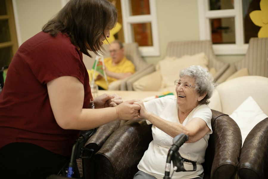Caregiver helping an elderly woman stand up